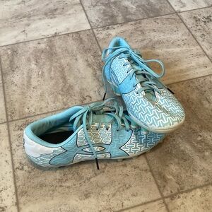 Under Armour force blue and white cleats. In good shape.